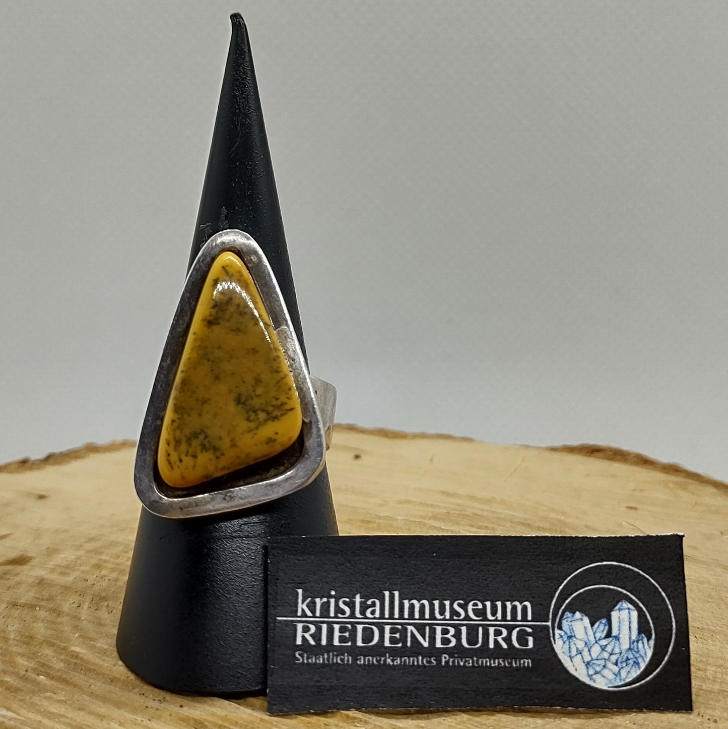 Außergewöhnlicher Ring mit einem dreieckigen opaken Bernstein in breiter Silberfassung.